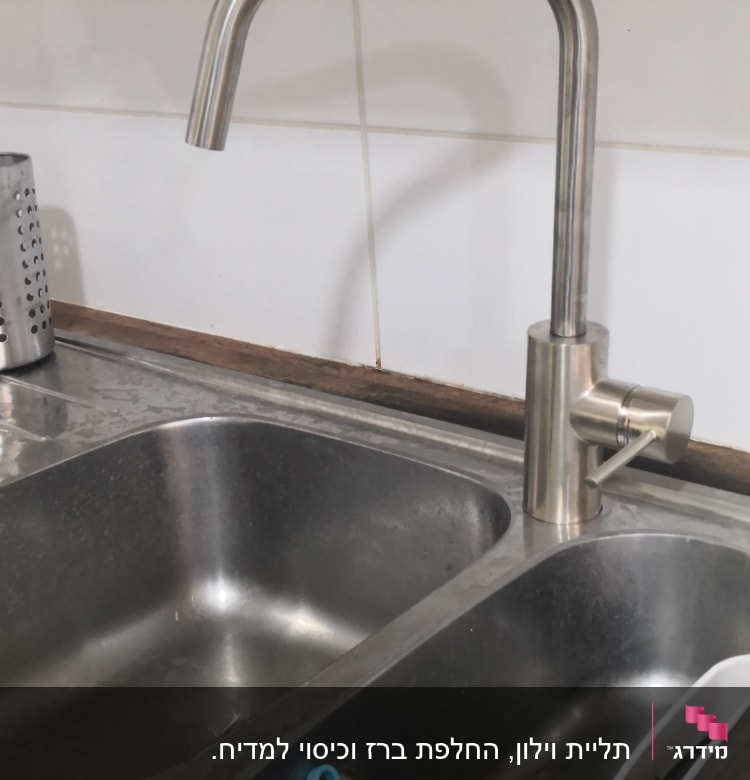 ברז נירוסטה מעל כיור כפול עם כלי עבודה כחול